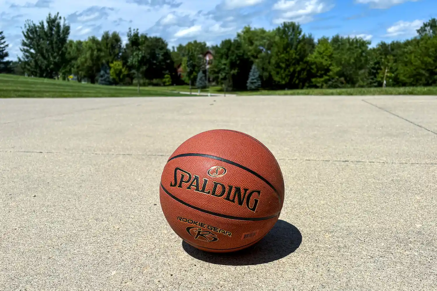 The Spalding Rookie Gear Youth Indoor-Outdoor Basketball on concrete