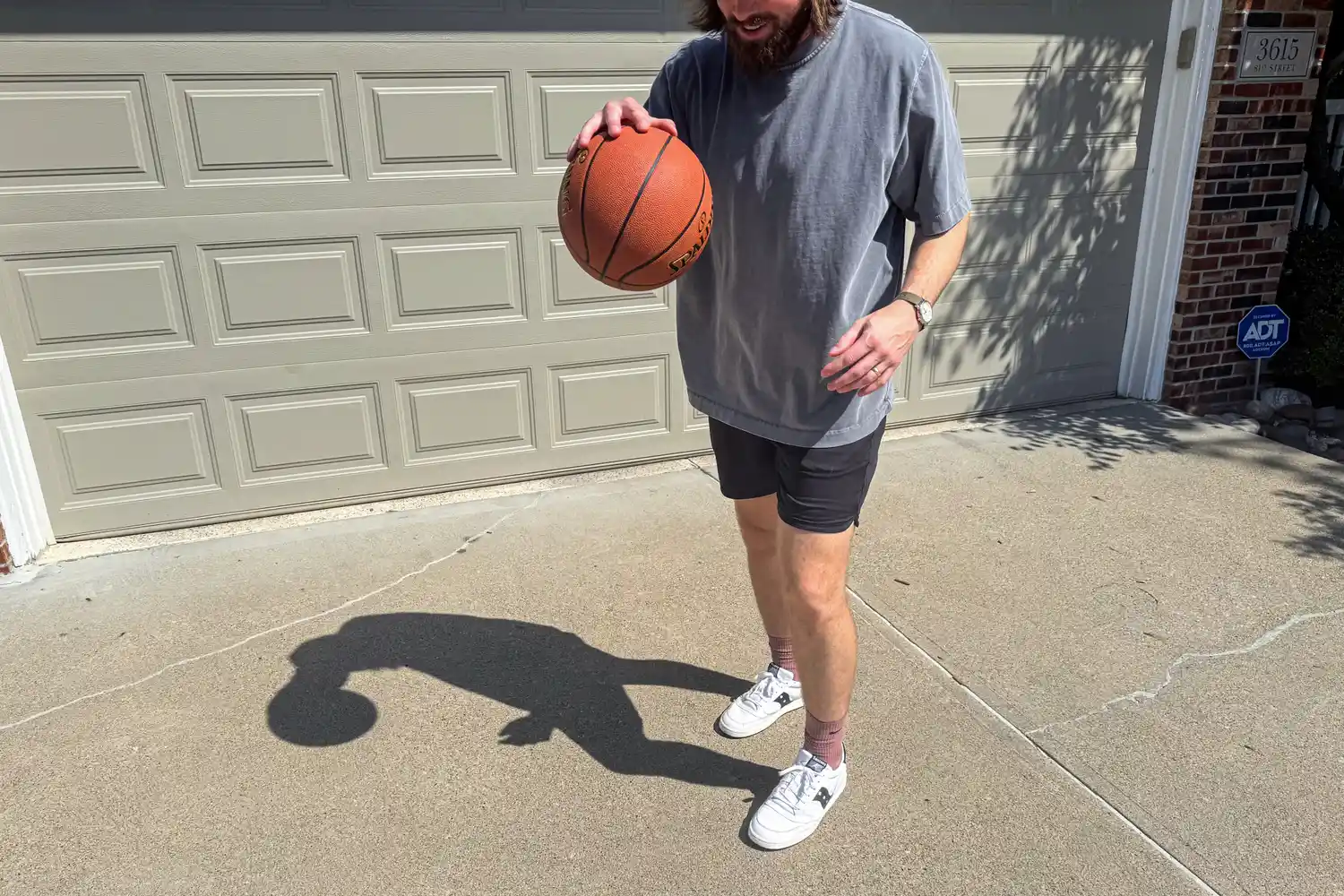 A person dribbles the Spalding Street Outdoor Basketball