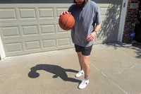 A person dribbles the Spalding Street Outdoor Basketball