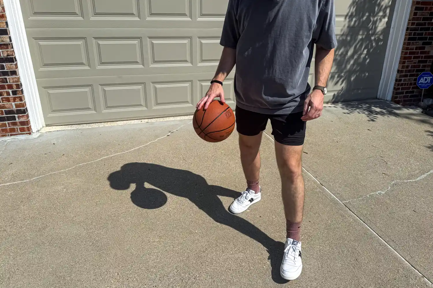 A person dribbles the Spalding Street Outdoor Basketball