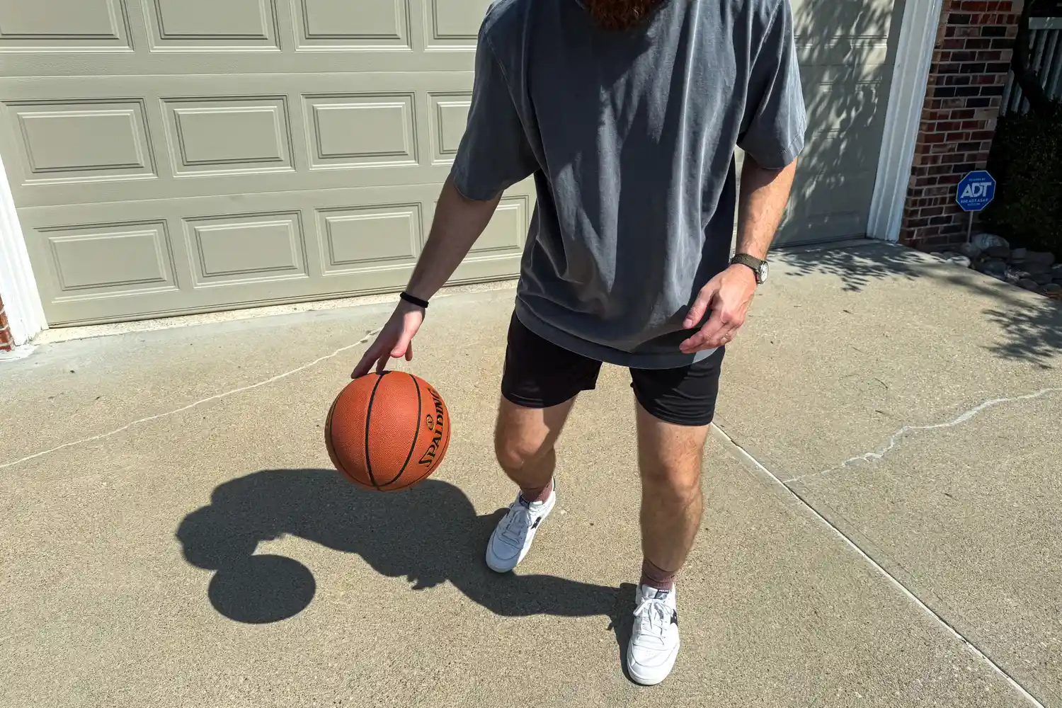 A person dribbles the Spalding Street Outdoor Basketball