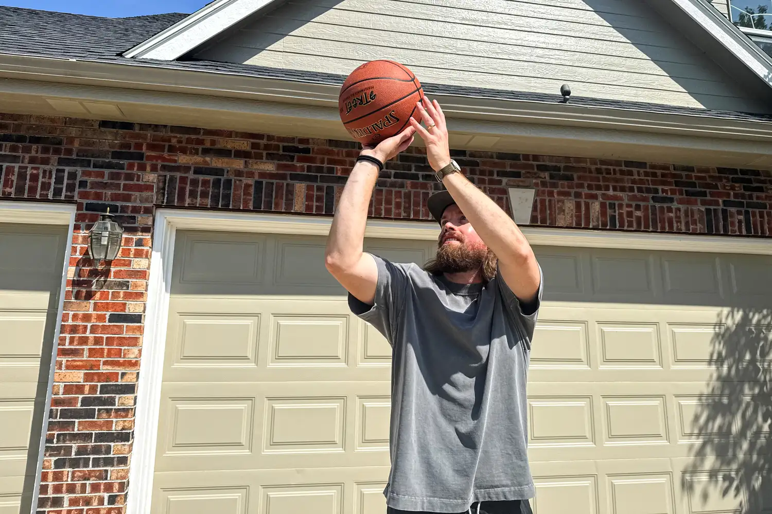 A person shoots the Spalding Street Outdoor Basketball