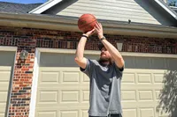 A person shoots the Spalding Street Outdoor Basketball