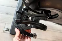 A person holds the pedal of the Spinning Aero Connected Spinner Bike