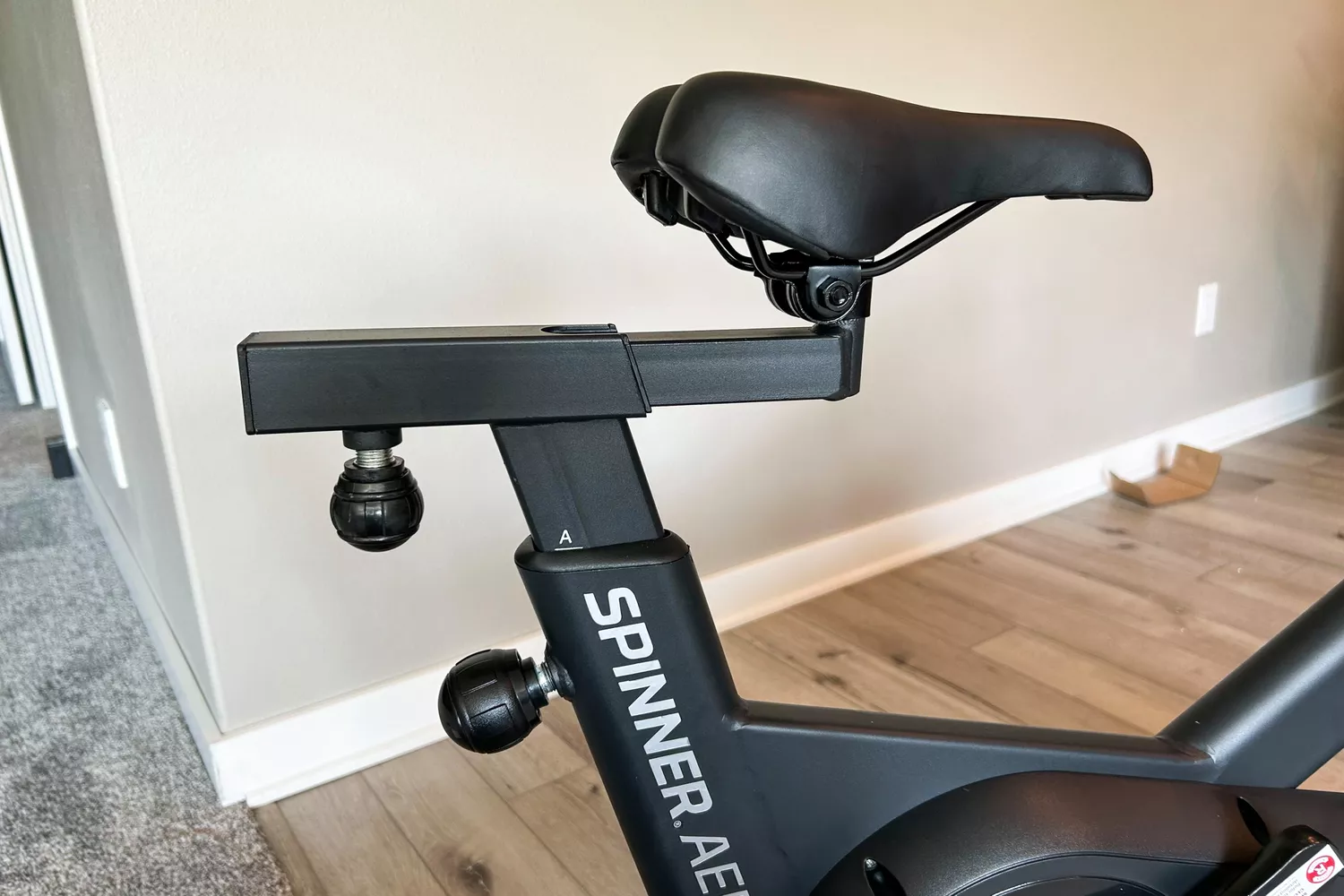 The seat height adjustment knobs on the Spinning Aero Connected Spinner Bike