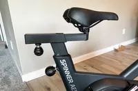 The seat height adjustment knobs on the Spinning Aero Connected Spinner Bike