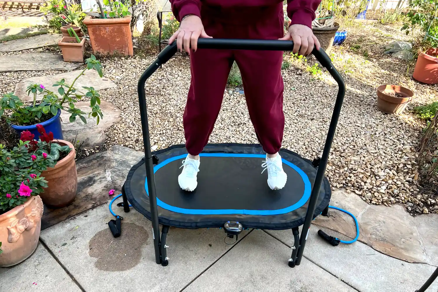 A person bounces on the Stamina Oval Fitness Trampoline