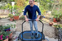 A person jumps on the Stamina Oval Fitness Trampoline