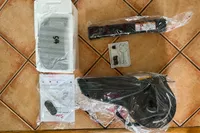 The pieces of the Sunny Health & Fitness SF-B0960 Motorized Electric Under Desk Bike on a tile floor