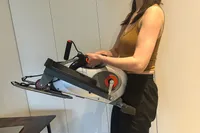 A person lifts the Sunny Health & Fitness Smart Stand/Sit Mini Elliptical Exercise Trainer