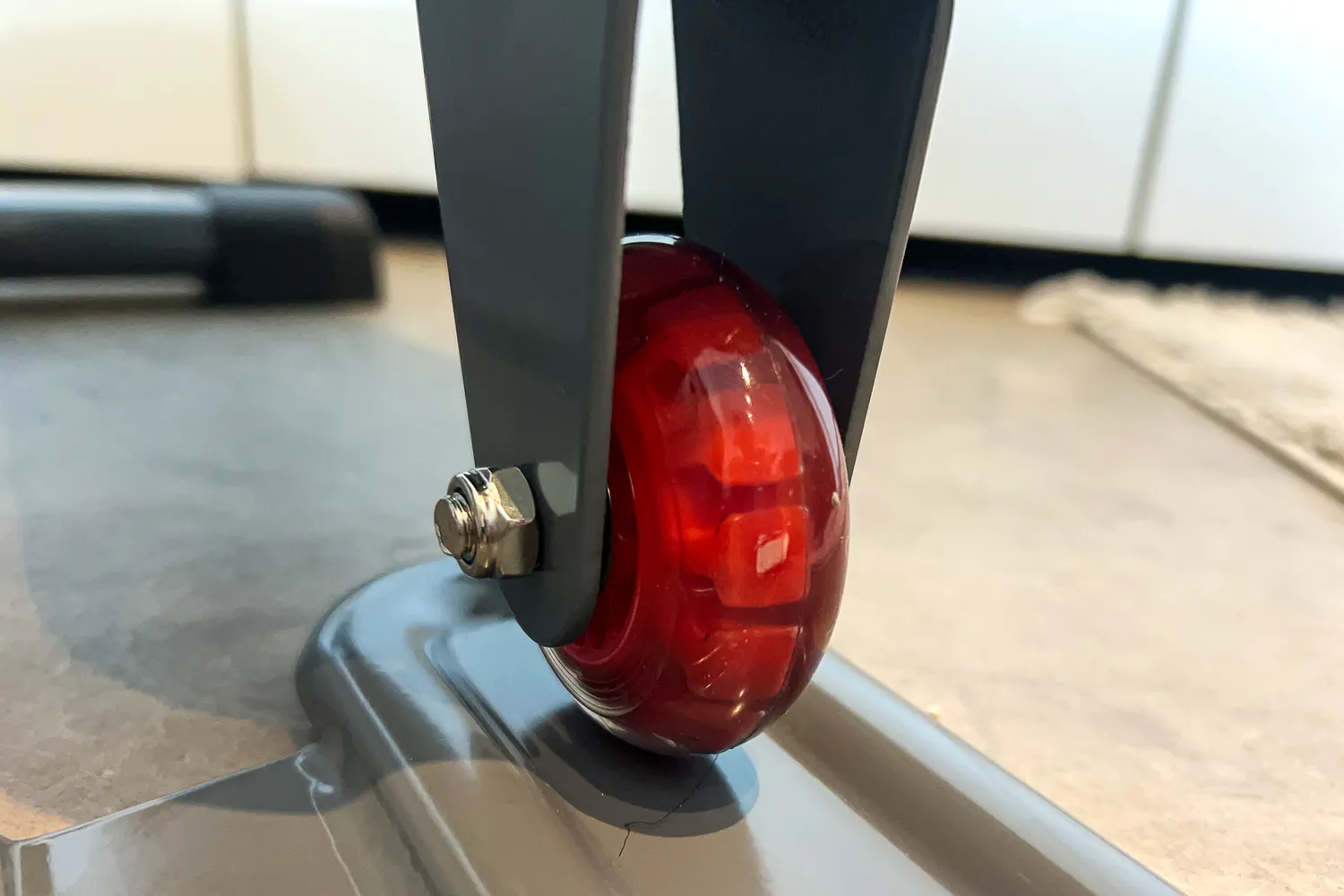 A wheel on the Sunny Health & Fitness Smart Stand/Sit Mini Elliptical Exercise Trainer