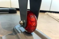 A wheel on the Sunny Health & Fitness Smart Stand/Sit Mini Elliptical Exercise Trainer