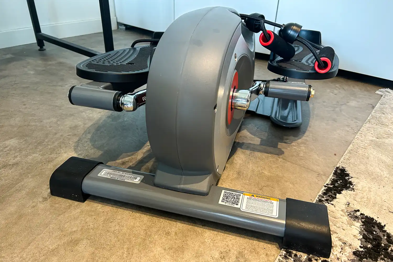 The back of the Sunny Health & Fitness Smart Stand/Sit Mini Elliptical Exercise Trainer