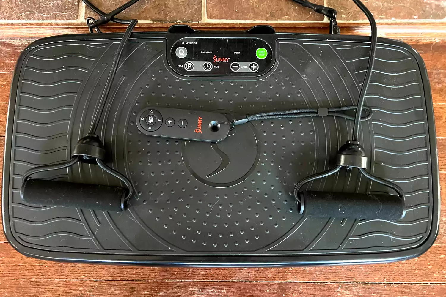 The Sunny Health & Fitness Fitboard 2D Vibration Platform With Resistance Band with remote control