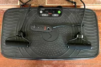 The Sunny Health & Fitness Fitboard 2D Vibration Platform With Resistance Band with remote control