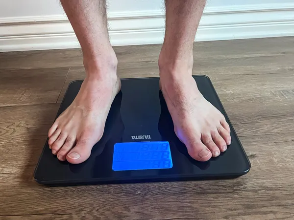 A person stands on the Tanita HD-384 Digital Bathroom Scale