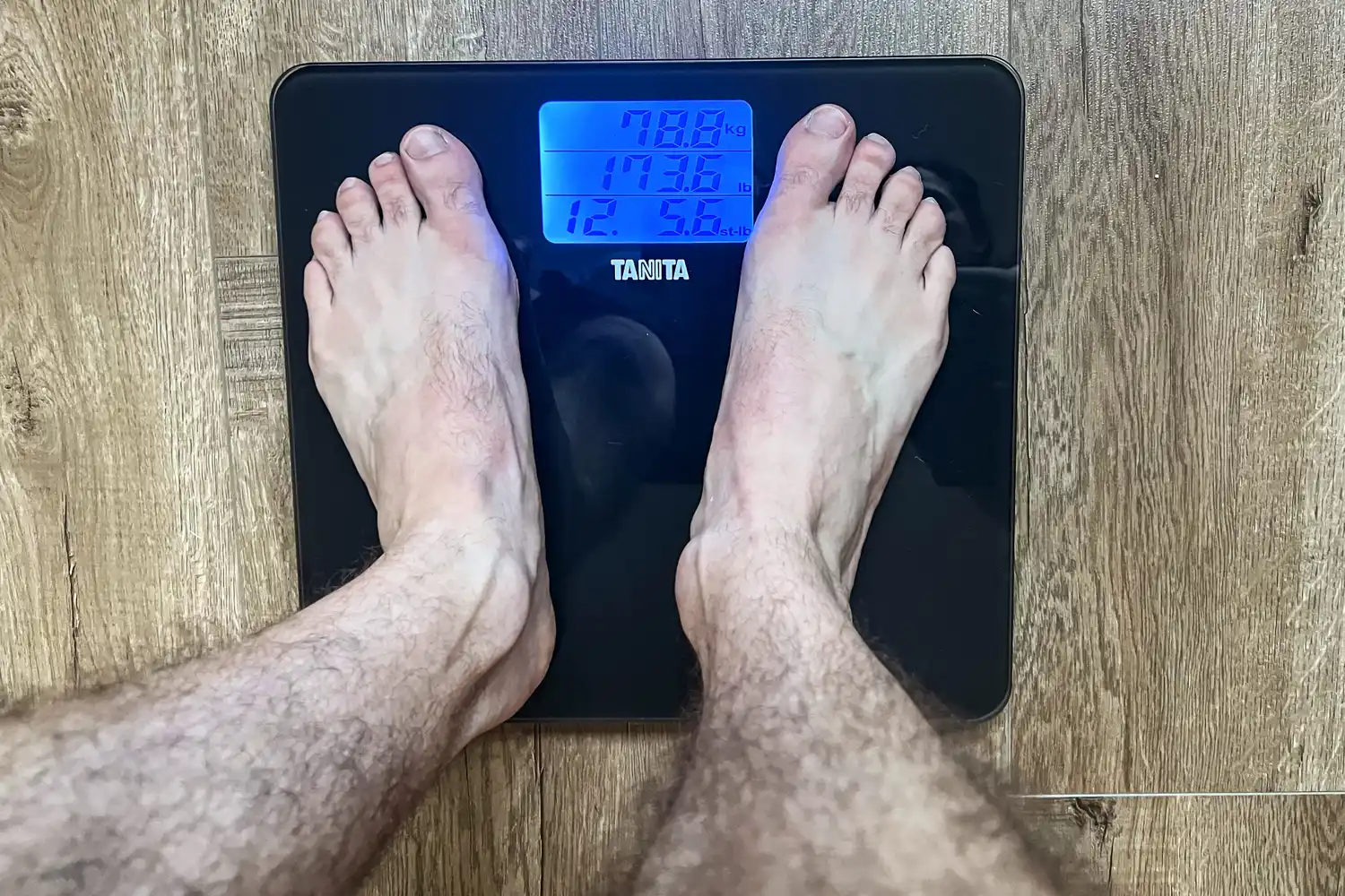 A person stands on the Tanita HD-384 Digital Bathroom Scale