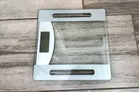 The Taylor Weight Tracking Smart Scale with Bluetooth Sync on a tile floor