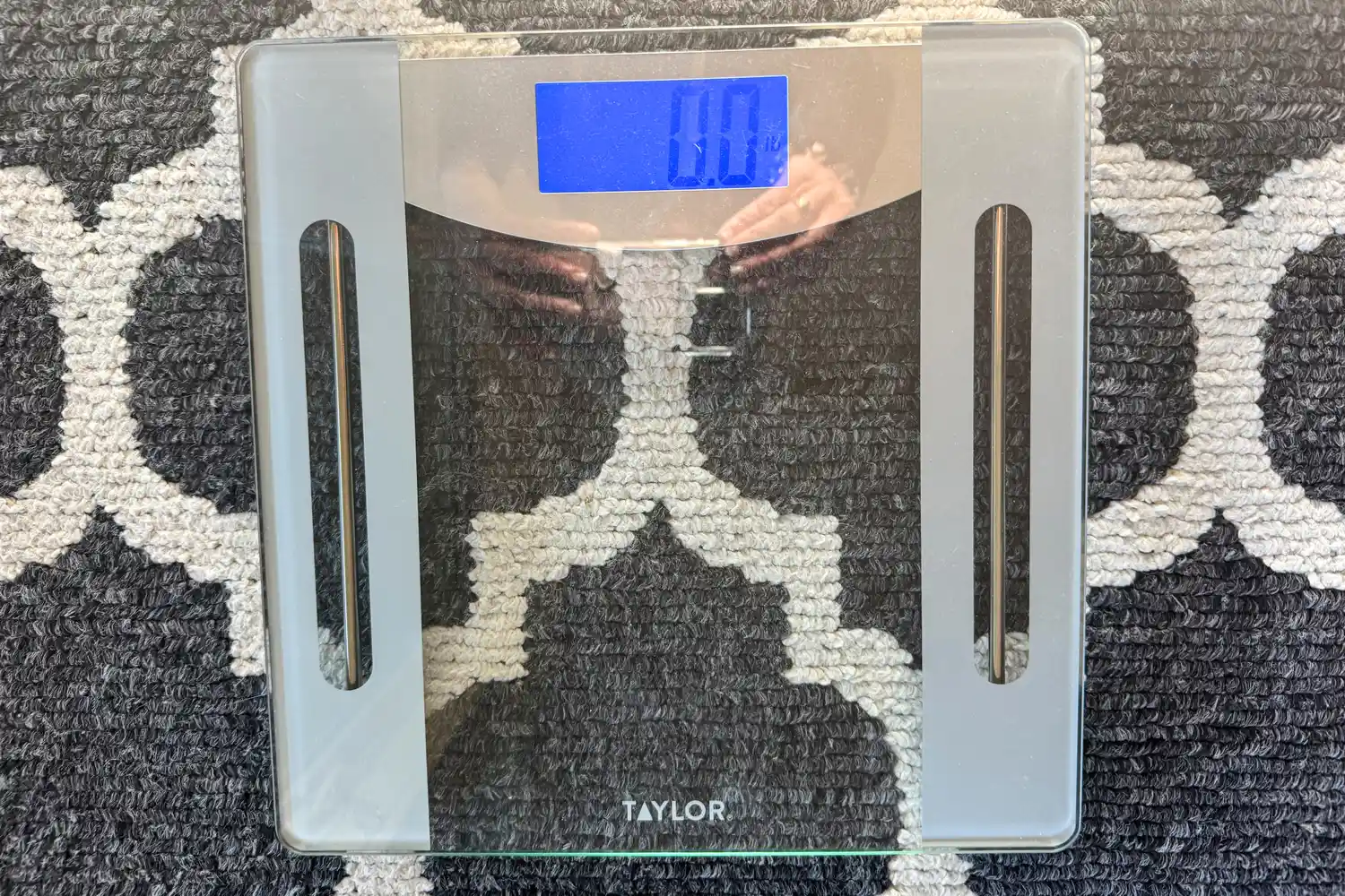 The Taylor Weight Tracking Smart Scale with Bluetooth Sync on a rug