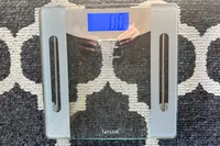 The Taylor Weight Tracking Smart Scale with Bluetooth Sync on a rug