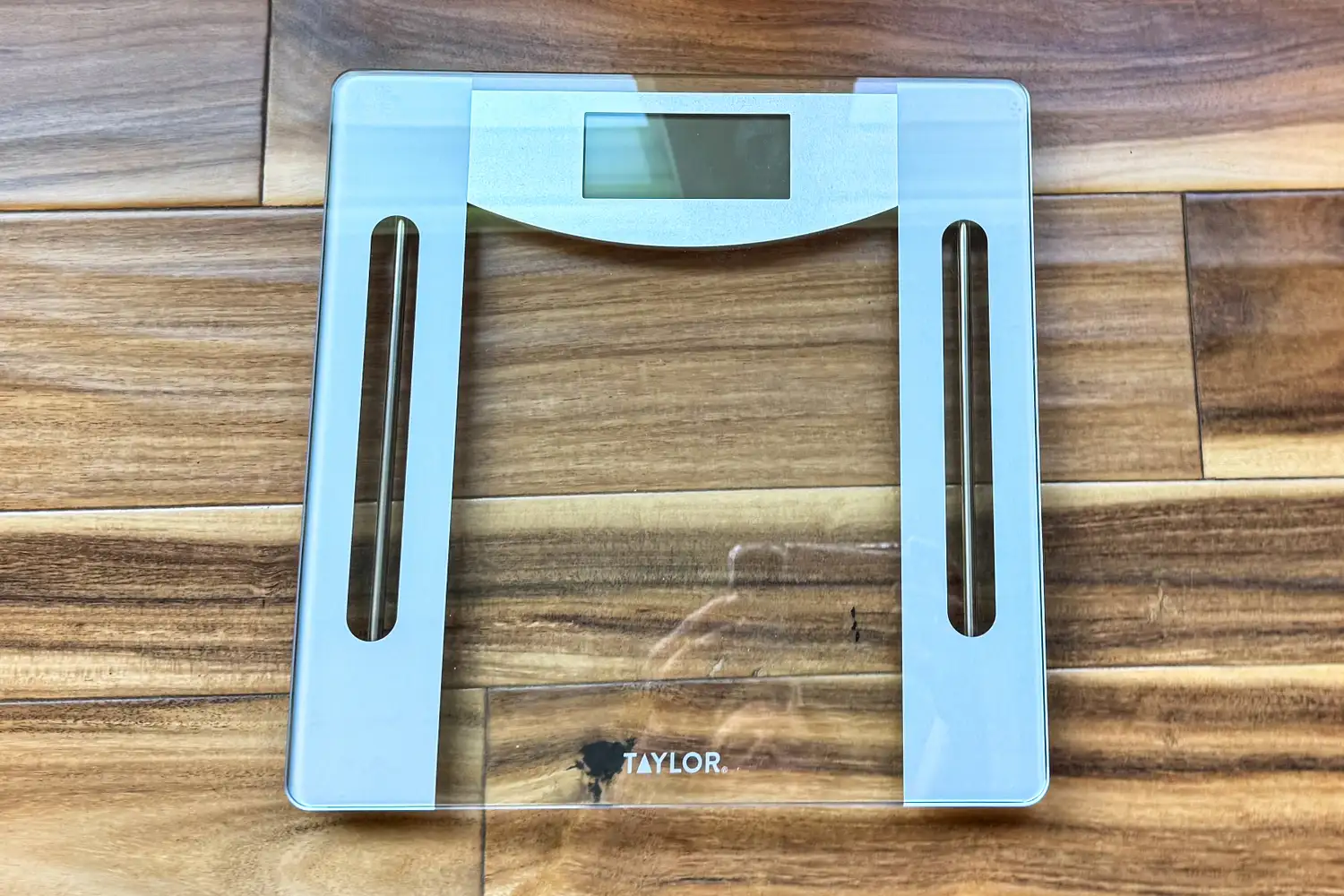 The Taylor Weight Tracking Smart Scale with Bluetooth Sync on a wooden floor