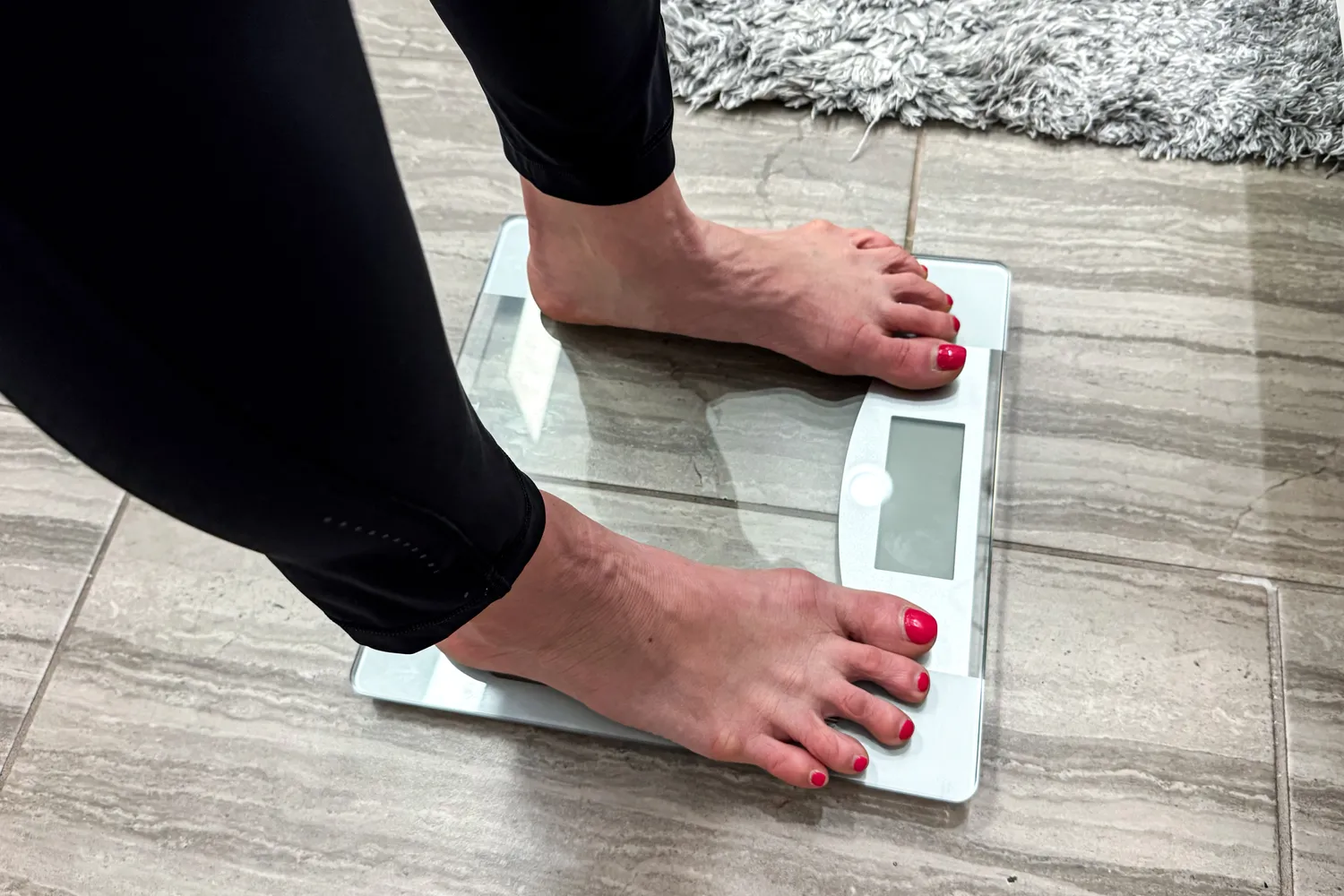 A person stands on the Taylor Weight Tracking Smart Scale with Bluetooth Sync