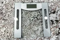 The Taylor Weight Tracking Smart Scale with Bluetooth Sync on a stone counter