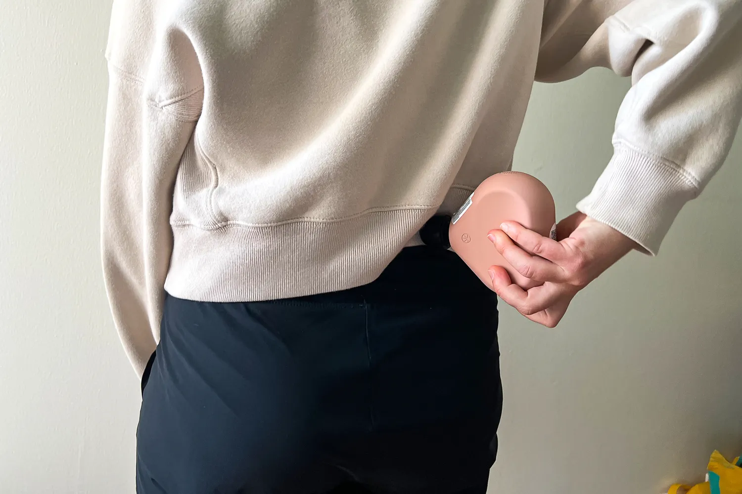 A person uses the Therabody Theragun Mini (3rd Generation)