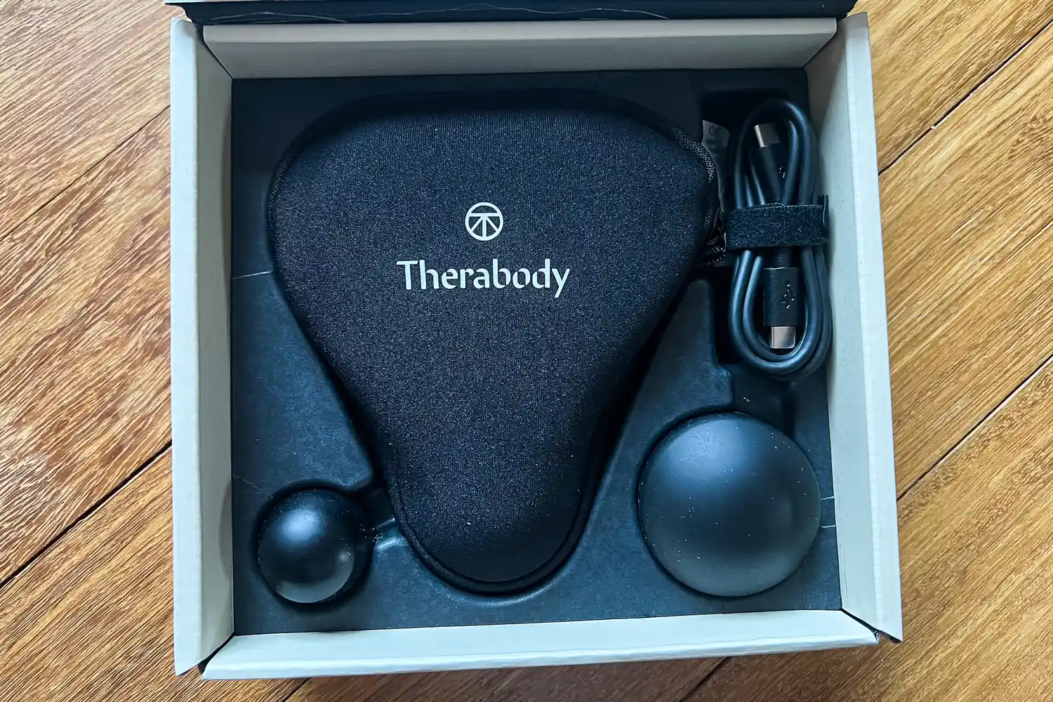 The Therabody Theragun Mini (3rd Generation) in a storage box