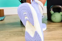 Person showing bottom of APL Streamline Running Shoes