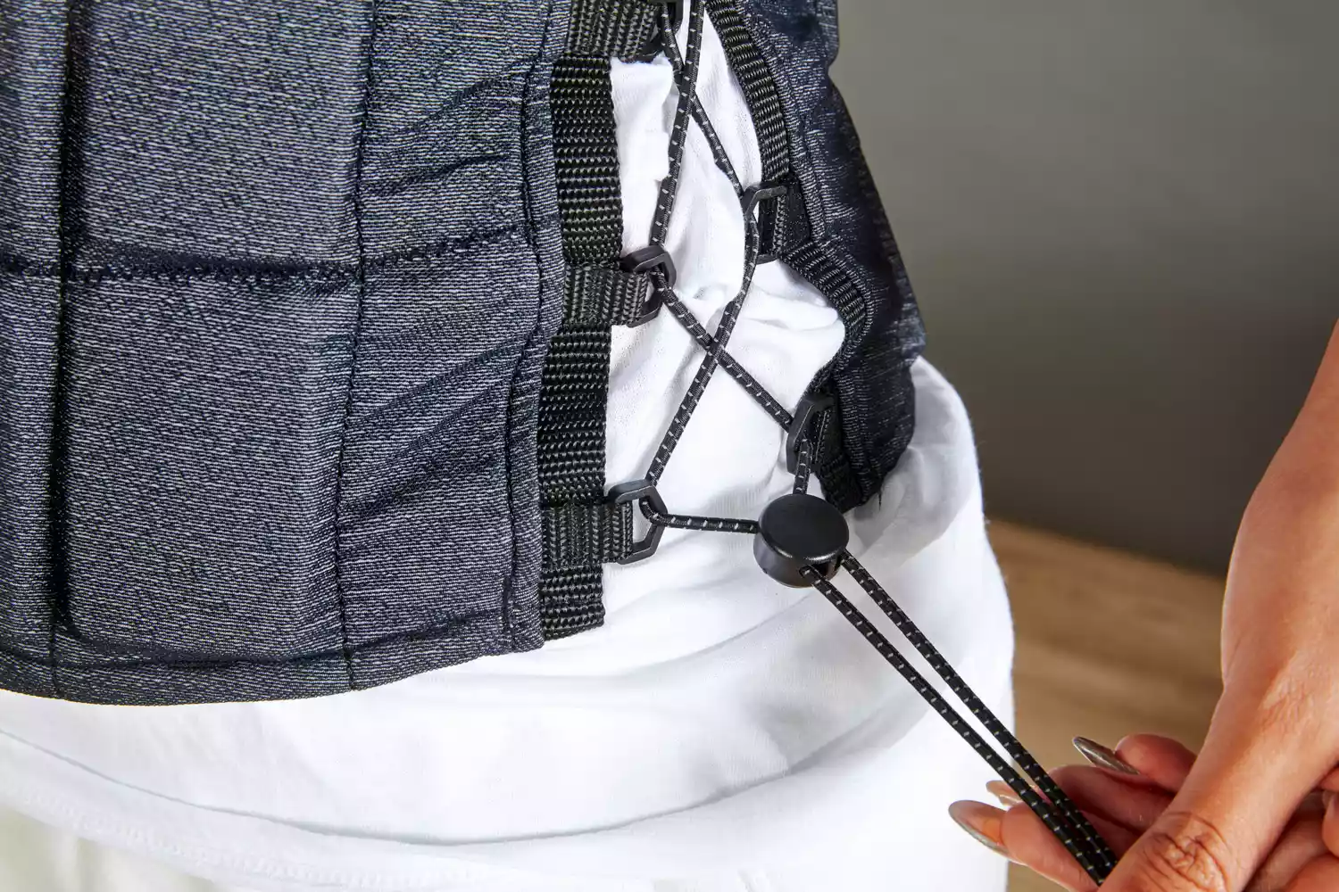 Person pulling strings on Hyperwear Hyper Vest Fit Weighted Vest for Women