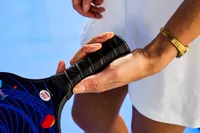 Person holding handle of Panel Sound USAPA Approved Fiberglass Pickleball Paddles Set