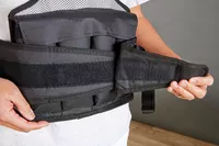 Person pulling strap of ZFOsports Weighted Vest
