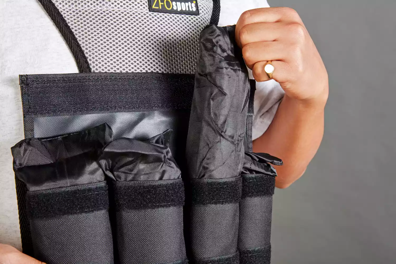Person pulling weight from ZFOsports Weighted Vest