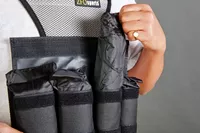 Person pulling weight from ZFOsports Weighted Vest
