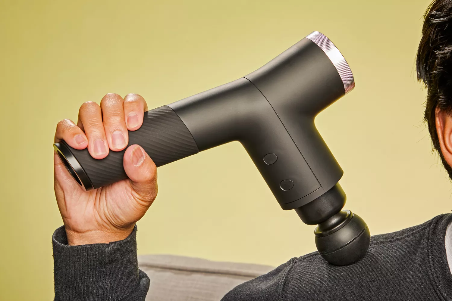 Person using Ekrin Athletics B37 Percussion Massager on shoulder