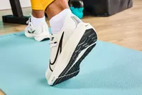 Person lifting heel wearing Nike Womenâs Pegasus 40