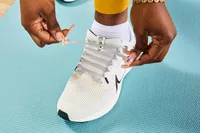 Person tying laces of Nike Women’s Pegasus 40