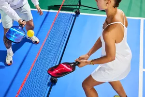 Person playing pickleball with Asbocer USAPA Approved Pickleball Paddles Set of 2