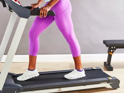 Person wearing lululemon Original Fast and Free High-Rise Crop while walking on treadmill