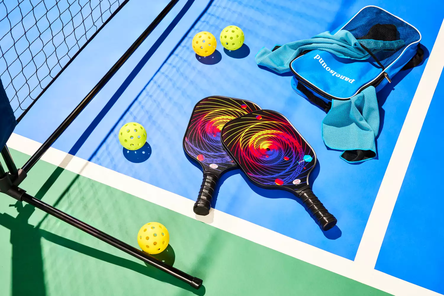 Panel Sound USAPA Approved Fiberglass Pickleball Paddles Set laying out on pickleball court