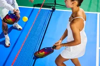 Person playing pickleball with Panel Sound USAPA Approved Fiberglass Pickleball Paddles Set