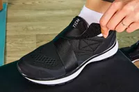 Person pulling tongue of TIEM Slipstream Women's Indoor Cycling Shoe