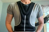 The front of a person wearing the Tone Fitness HHWV-TN Weighted Vest