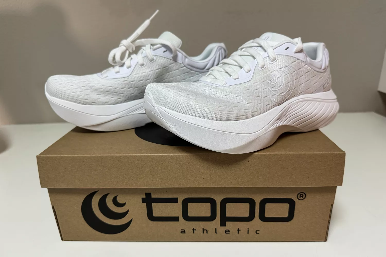 A pair of Topo Athletic Women's Atmos Running Shoes on a shoebox