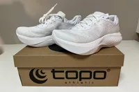 A pair of Topo Athletic Women's Atmos Running Shoes on a shoebox