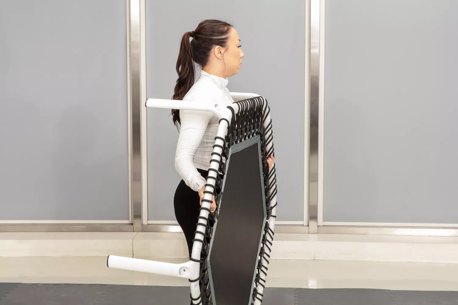 Person carrying Acon 55in Trampoline Hexagon