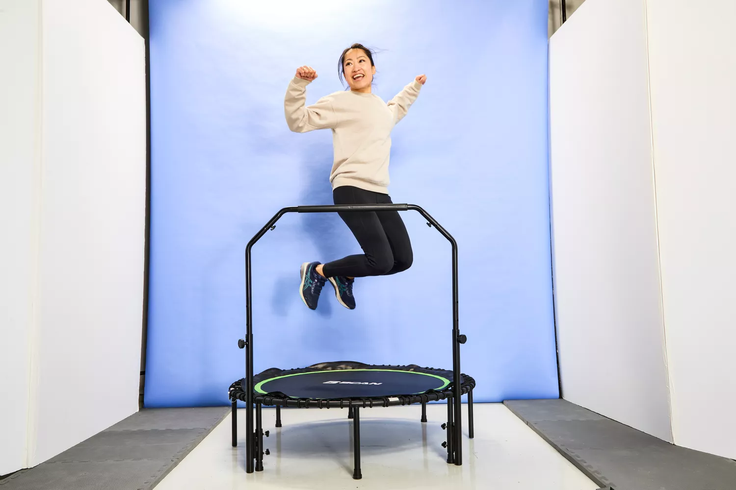 A person with knees bent in the air above the BCAN 450/550 Lbs Foldable Mini Trampoline