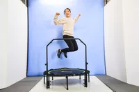 A person with knees bent in the air above the BCAN 450/550 Lbs Foldable Mini Trampoline
