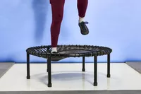A close-up of legs moving on the bellicon 39 Inch Mini Trampoline